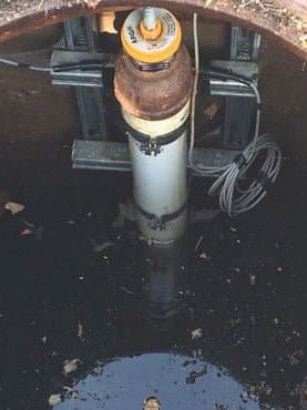 MNU Ultrasonic Sensor mounted under a manhole cover in a sewer application