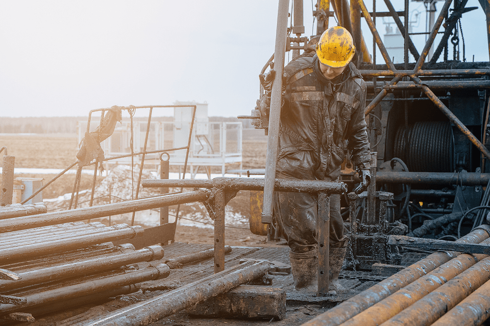 oil rig worker covered in drilling mud
