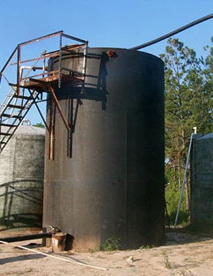 A lease tank for oil waiting to be picked up by a truck