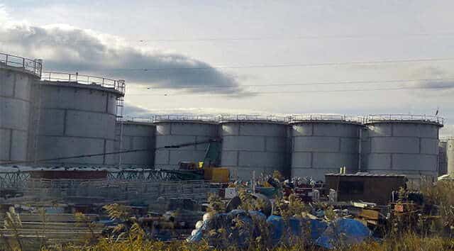 liquid storage tanks in a field